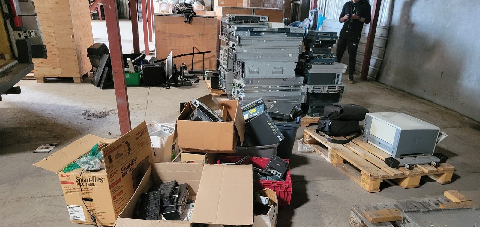 Commercial electronics cleanout with computers, servers, monitors and networking equipment ready for processing